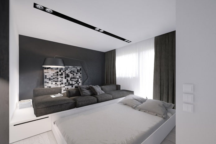 интерьер гостиной-спальни с кроватью в подиуме