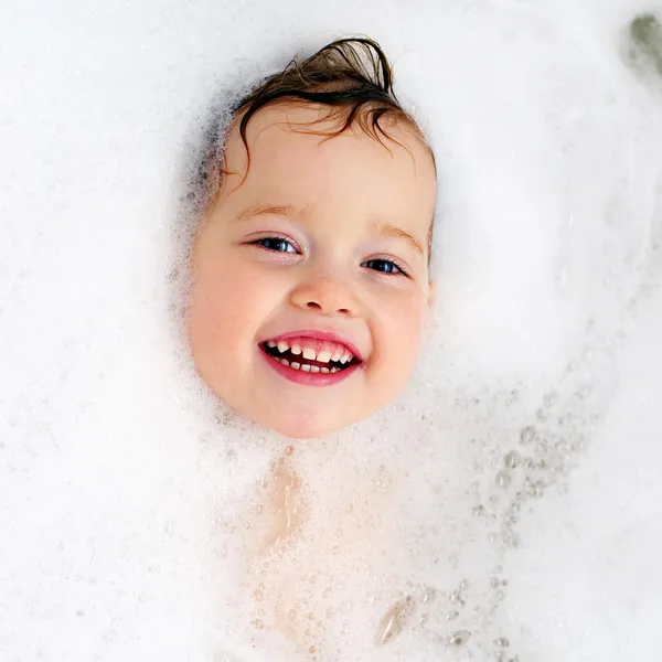 Счастливый малыш в бане, купаясь в пену. Baby Душ — стоковое фото