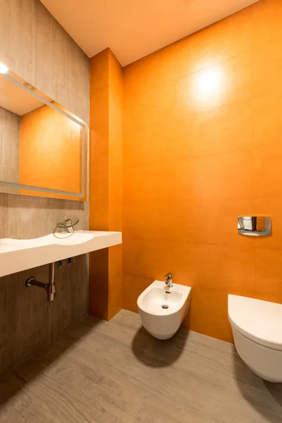 Interior Modern Bathroom Orange White Colors Toilet Bidet — стоковое фото