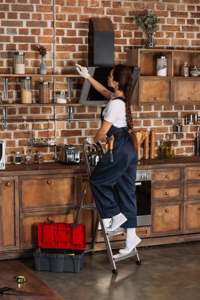 Beautiful Young Repairwoman Standing Stepladder Kitchen — стоковое фото