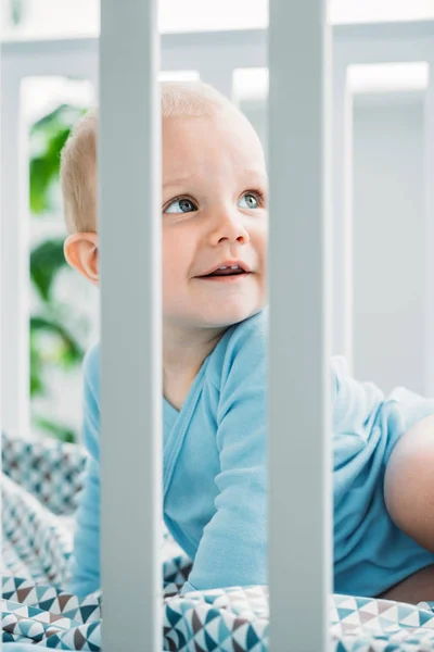 Adorable Little Baby Lying Crib Looking Away — стоковое фото