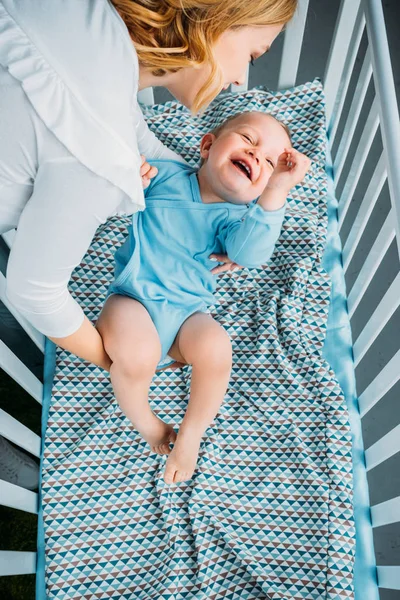 High Angle View Mother Putting Her Little Child Crib — стоковое фото