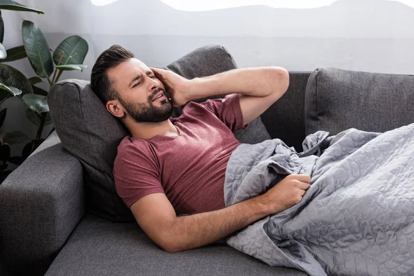 Stuffering Young Man Headache Lying Couch — стоковое фото