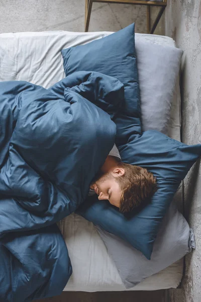 Top View Young Handsome Man Sleeping Blanket His Bed Home — стоковое фото