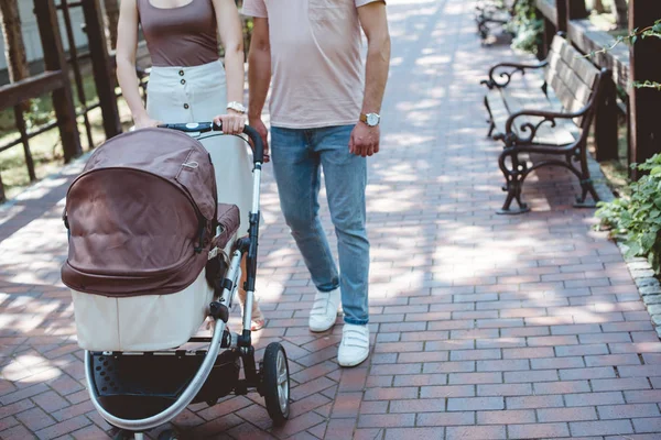 Cropped Image Parents Walking Baby Carriage Park — стоковое фото