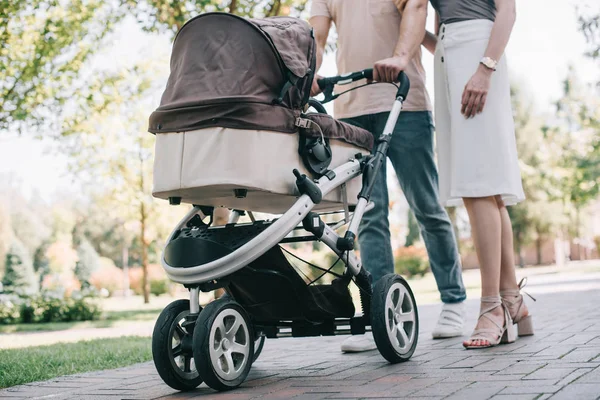 Cropped Image Mother Father Walking Baby Carriage Park — стоковое фото
