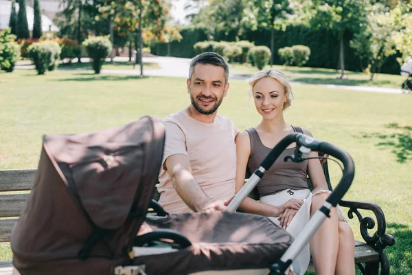 Happy Parents Sitting Bench Baby Carriage Park — стоковое фото