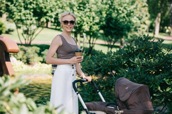Mother Walking Baby Carriage Park Holding Coffee — стоковое фото