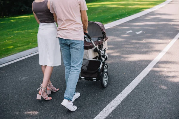 Cropped Image Parents Walking Baby Carriage Road Park — стоковое фото