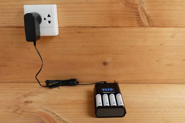 Battery Charger Battery Size Rechargeable Wooden Table — стоковое фото
